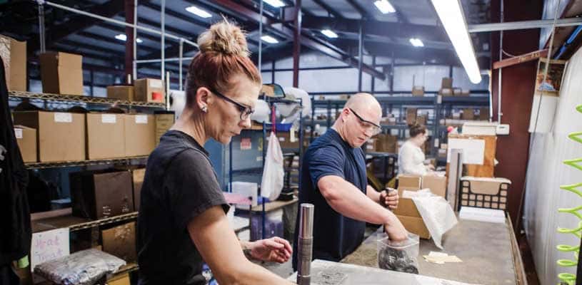 Empoyees inspecting recently machined parts