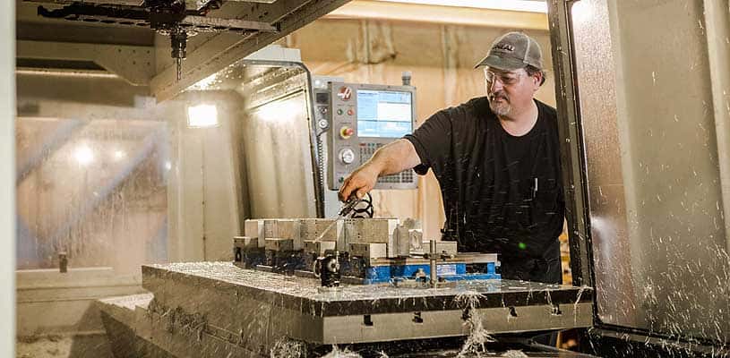 Technician operating a CNC milling center