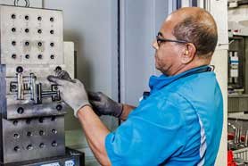 Machinist operating a CNC milling machine