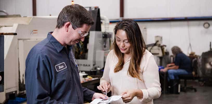 Machinist and engineer reviewing a product design